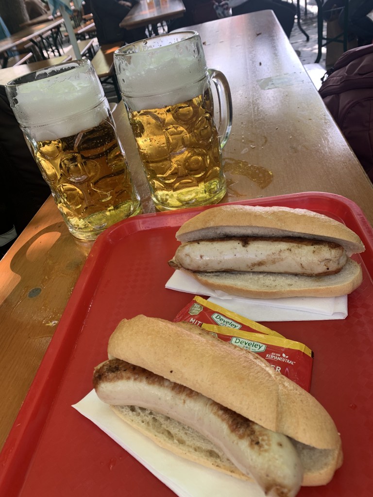 A photo of bratwurst and beer at the Viktualienmarkt in Munich, Germany
