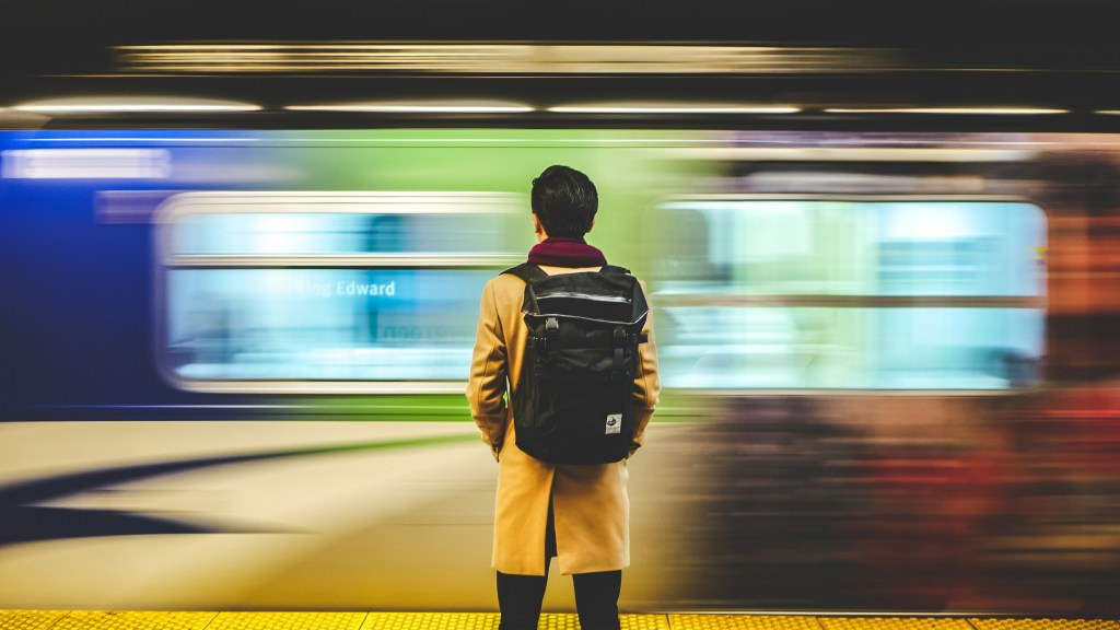 A man with a backpack in a train station